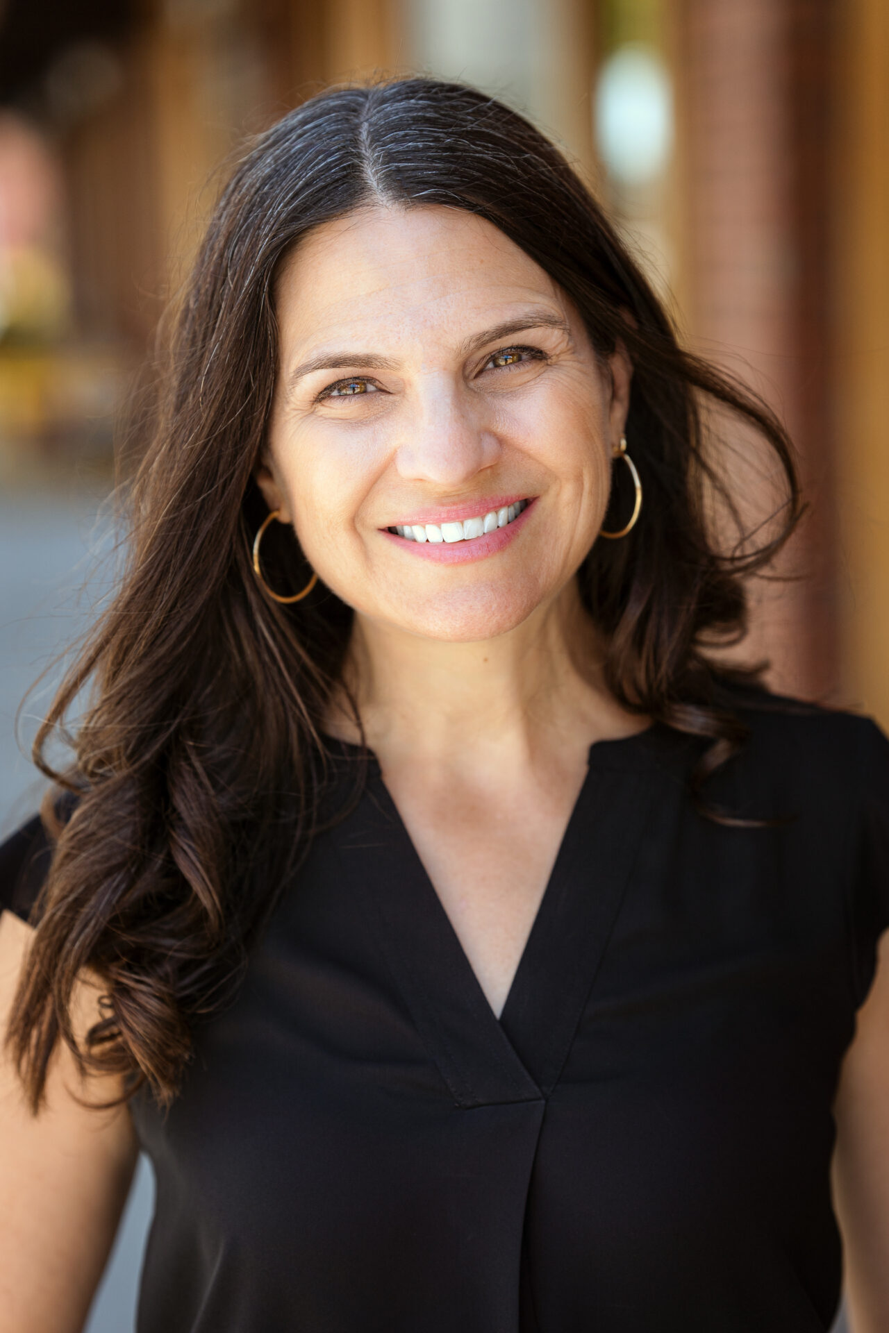 portrait of Sharon Brous from mid-torso up, smiling at the camera